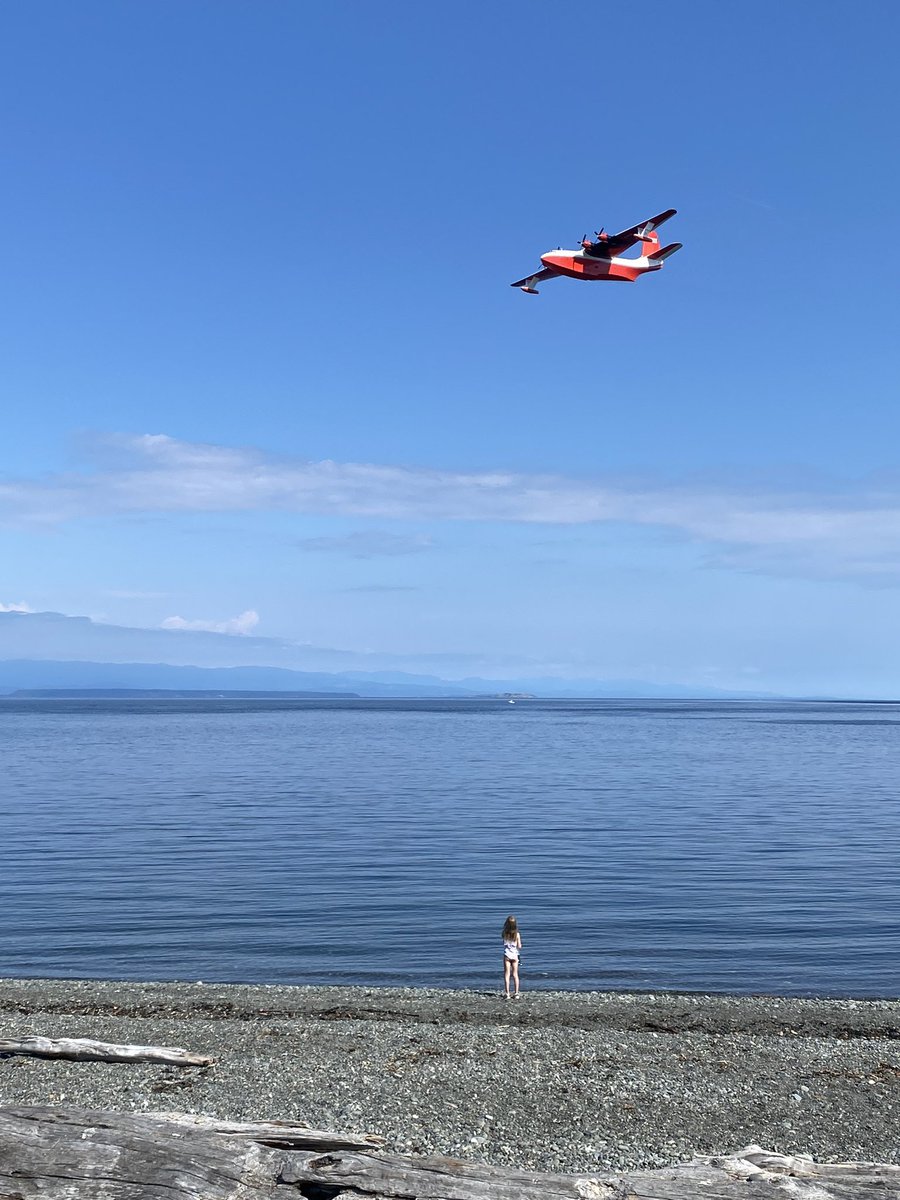 M_C_Dougherty's tweet photo. My daughter watching the @CoulsonAviation #martinmars water bomber fly it’s final flight over Campbell River today. https://t.co/RIZGBxKQZz