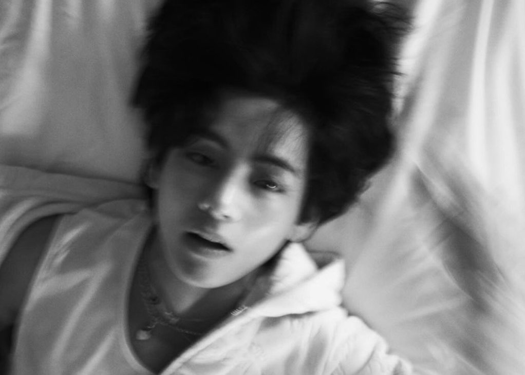 In black and white vibes, I lie back on the bed, with my hair captured by the camera lens flipped this time, creating a striking and bold contrast.