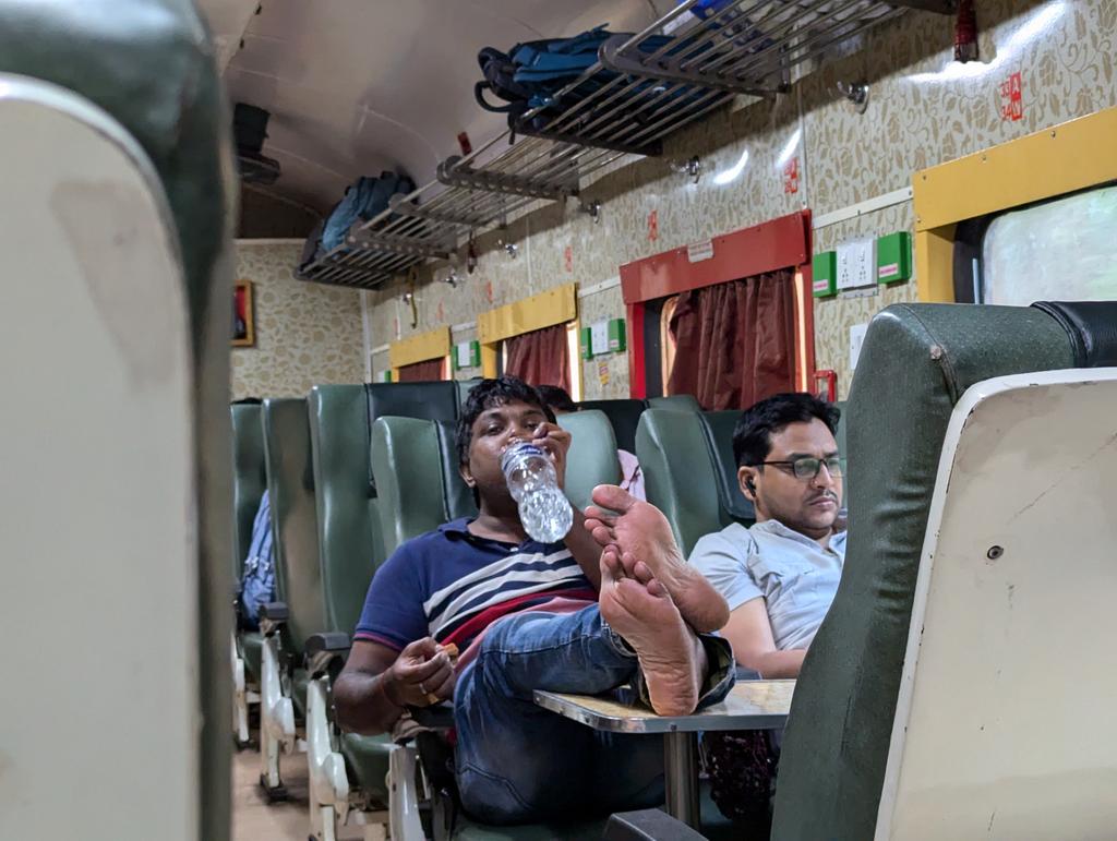 Do you like such travellers in the train? Legs up in the centre table...Should you not ban them from travelling
