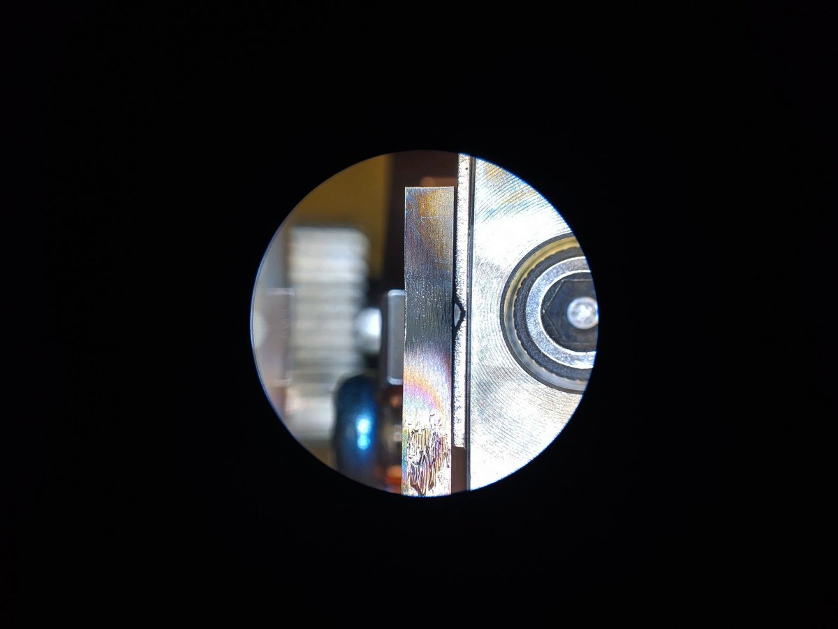 atthemicroscale's tweet photo. And these pics show the sample holder and a silicon sample in it, after about 30 minutes of polishing. The small darker dimple is the polished bit. The beam is quite narrow in this case. One of the photos is taken through the beam observation window while the beam was still on. https://t.co/kjnHyHzaFt