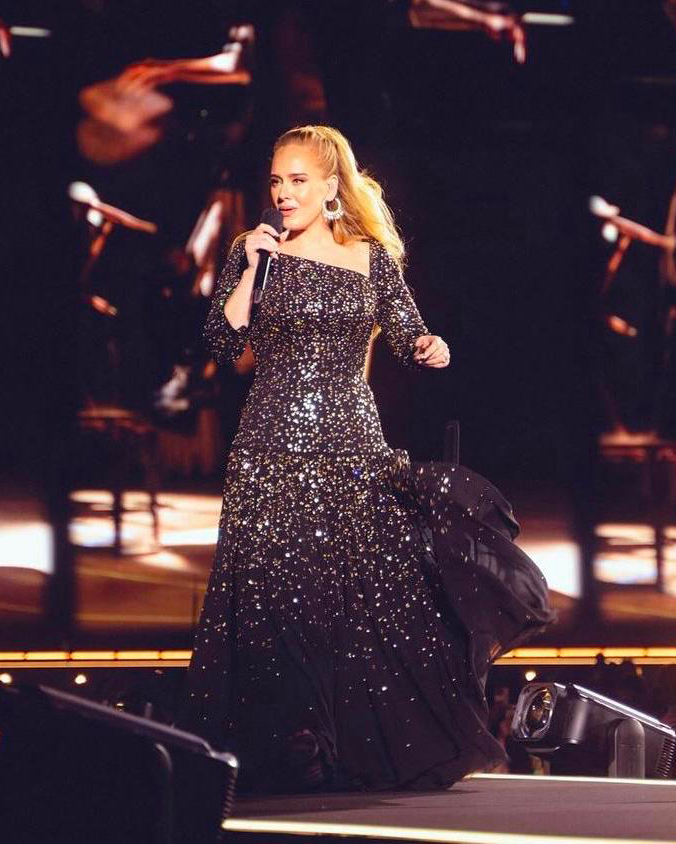 Adele in Louis Vuitton. Taking the stage for her concert in Munich, the  British singer was dressed in a custom Louis Vuitton gown by Nicolas  Ghesquire  adorned with dazzling gold detailing. #