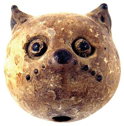 Small glass cathead amulet with a hole for wearability. Culture: Egypt, c. 500-300 BC. Private Collection.