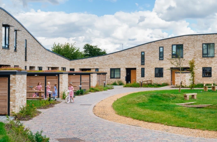 Another suburban housing development featuring playful, sociable shared space, with cars and parking spaces well out of the way. More's Meadow, a 21-home scheme in Great Shelford, Cambs. Architect: Haysom Ward Miller. photo credit Richard Fraser. via <a href="/ArchitectsJrnal/">Architects’ Journal</a>.