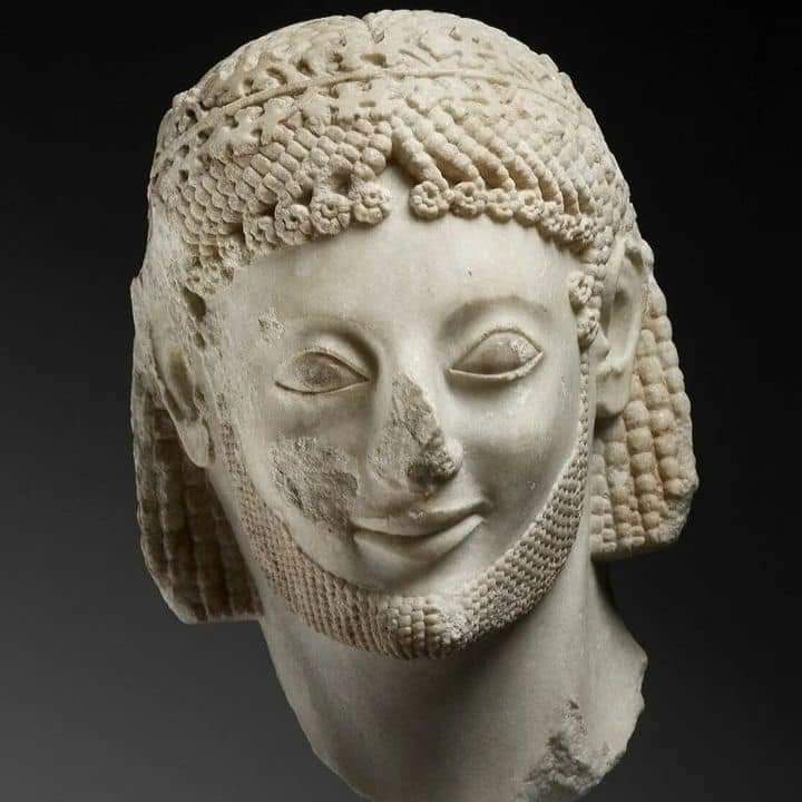 Archaic Smile :

The archaic smile is most commonly found in sculptures made during the Archaic period of ancient Greek art, between 650-840 BC, especially those made in second quarter of 6th Century BC.

It is used to describe the facial expression of Greek sculptures from the