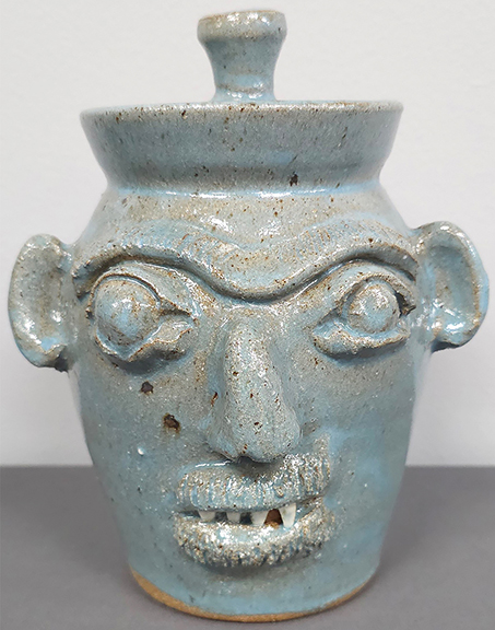 AntiqueDigest's tweet photo. Burlon Craig (1914-2002) early 1970s lidded face jar features bulging eyes, china teeth, & a seldom-seen glaze. The 8¼" high jar sold for $977.50 (e $375/625) at Cagle Auction https://t.co/YVKZ56dZkb #antiques #antique #art #artist #Americana #pottery #potter #facejug #folkart https://t.co/cqyAAm4Bsp