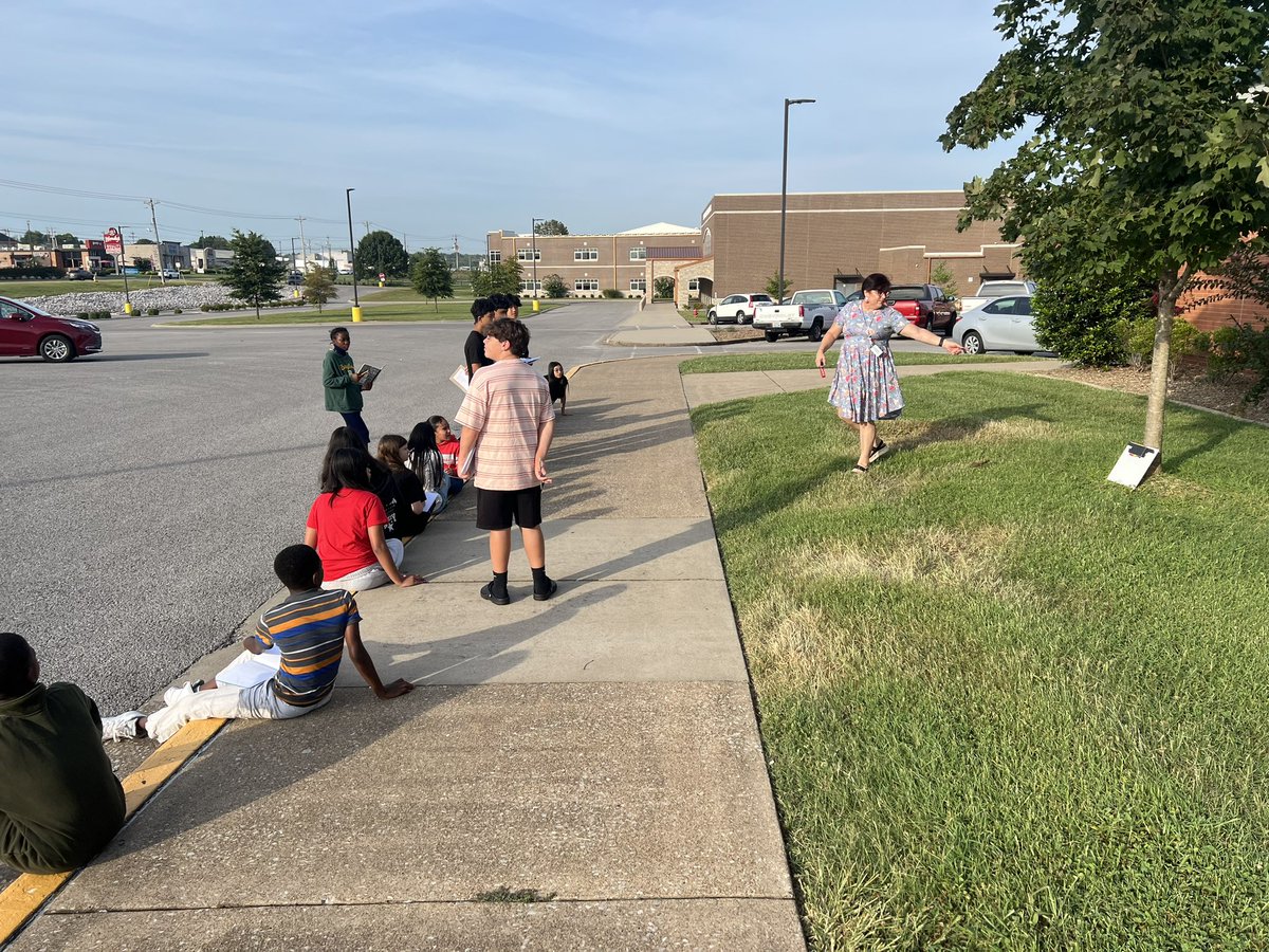Mrs. McMillen teaching students outside in the nice weather about the scientific method and how to make observations!  Go DRAGONS!