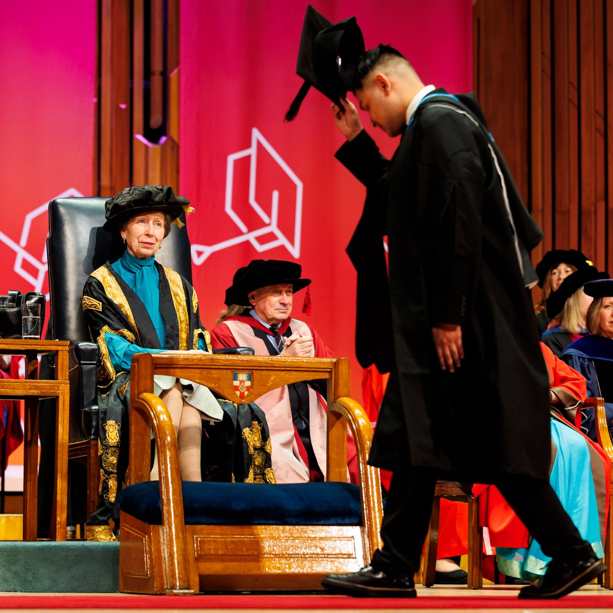 A student raises his cap to Her Royal Highness The Princess Royal