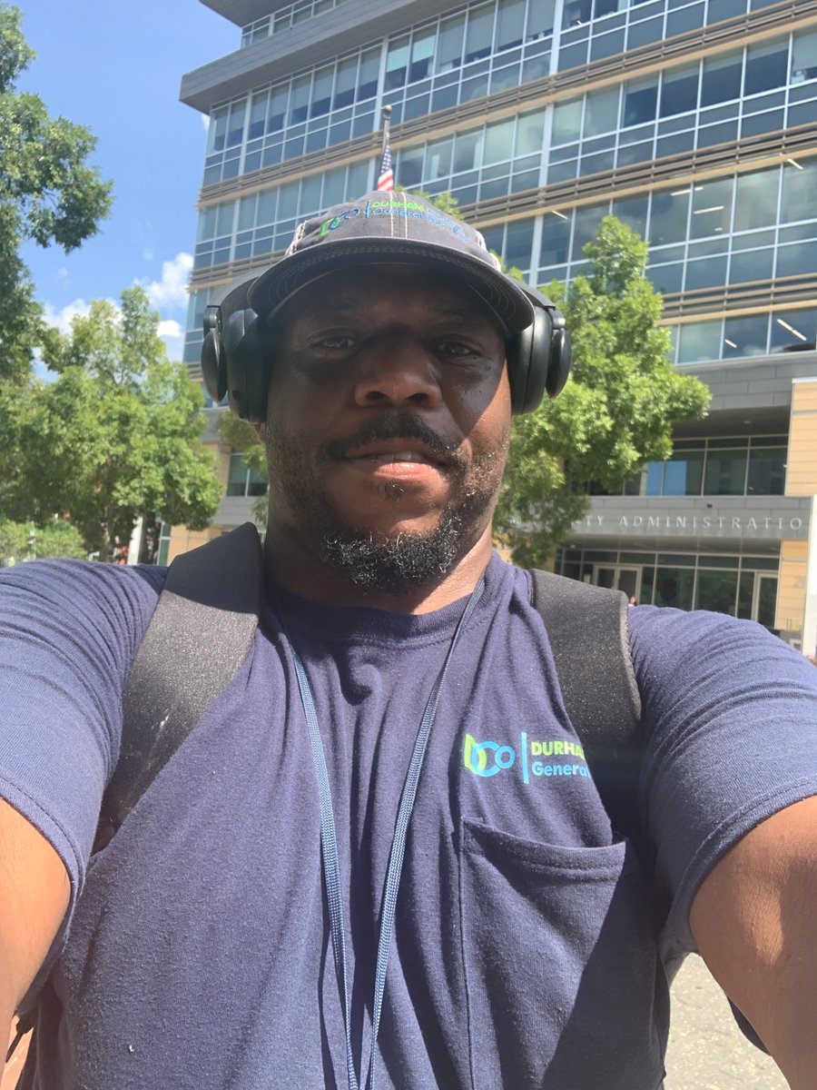 DurhamCounty's tweet photo. Kelvin and Phillip with General Services took a moment out from helping keep our buildings looking awesome on this hot afternoon to snap a couple pics for #CityHallSelfie day w/ the Admin II Building in the background. Hugs props for all the work GS does! #DCoRocks @ELGL50 https://t.co/RtVrkp1zJ9