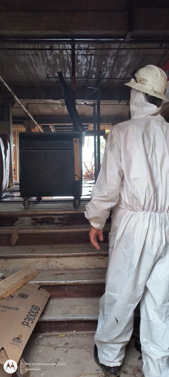 Demolition worker checking the open front door for intruders. The door was still unsecured at 579 McDermot.
