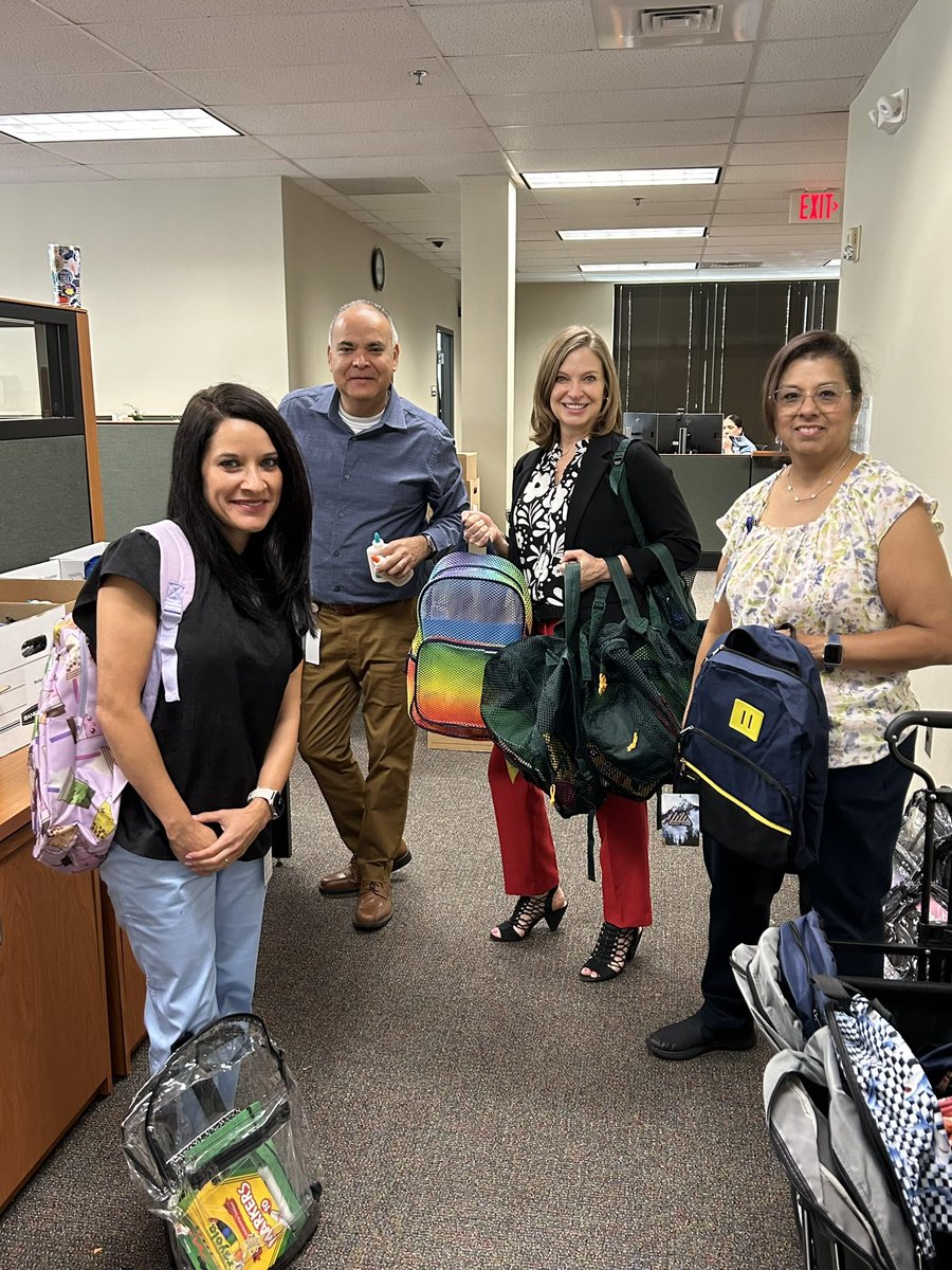 NISD Counseling Leadership Team members hard at work stuffing and distributing backpacks!