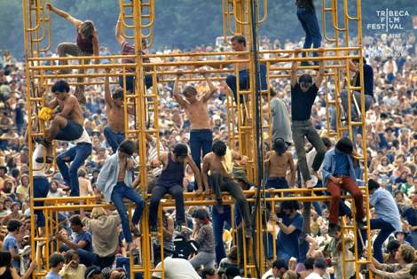 Woodstock 1969: an iconic photo of wannabe hippies dangling from the light towers.  There were mostly dudes in attendance at Woodstock,  just look at any crowd photo.