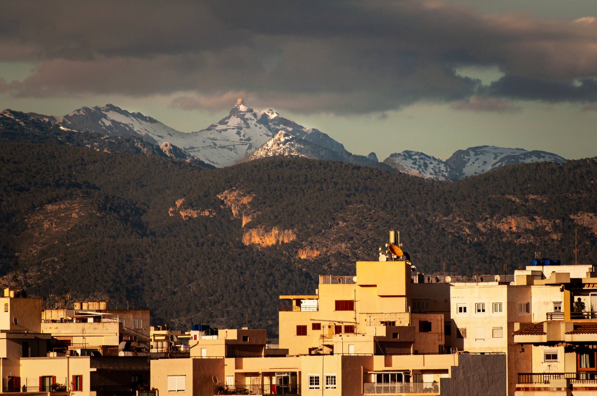 The Serra de Tramuntana mountains on the  island of Mallorca provide a spectacular backdrop when looking across  the rooftops of Palma and are occasionally covered in snow in the winter  months #majorca #mountains #travelphotography #photographylovers #landscapephotography