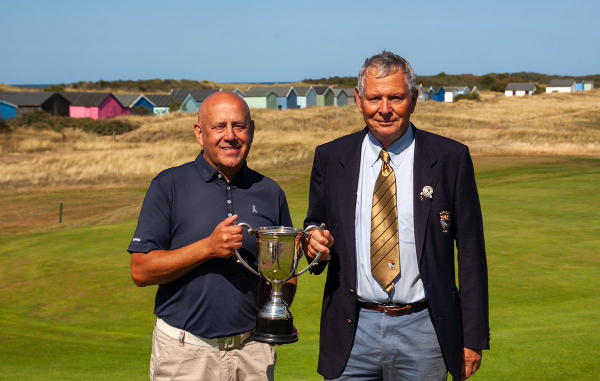 NCGU1908's tweet image. Mark Butt receives the Norfolk Seniors' Championship silverware from NCGU president Bob Carrick. Mark matched the fabulous weather and the immaculate course at Hunstanton Golf by shooting a superb level-par 72 - good enough for a three-stroke success