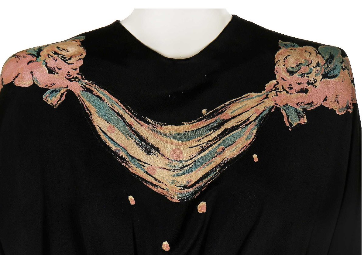 kateStrasdin's tweet photo. #GilbertAdrian was famously fond of a playful and painterly print, as modelled here by #JoanCrawford in her 1943 dinner gown. Made from navy blue rayon crepe, it features rosy cherubs holding aloft swags of cloth. Hollywood chic via @KerryTaylorAuct #fashionhistory https://t.co/2jMqFJdj6G