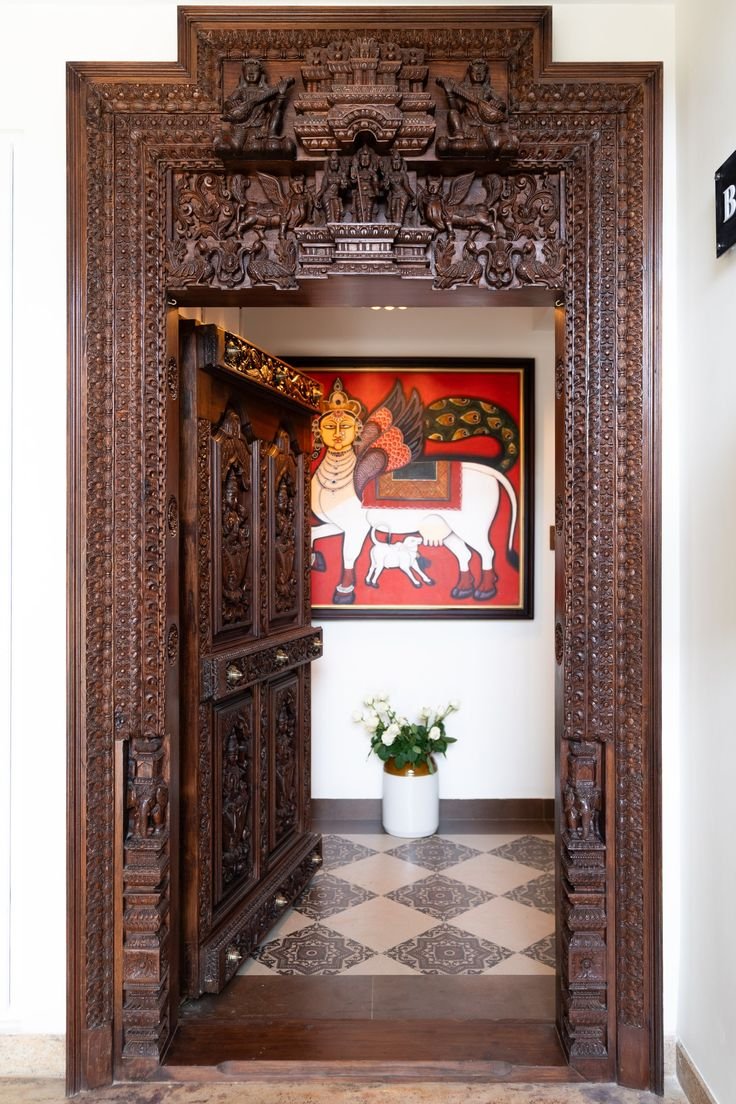 an intricately carved wooden gate from tamil nadu.