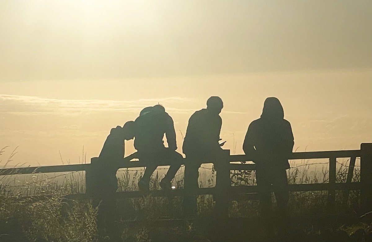 Silhouettes. Watching the sun setting over Manchester.
