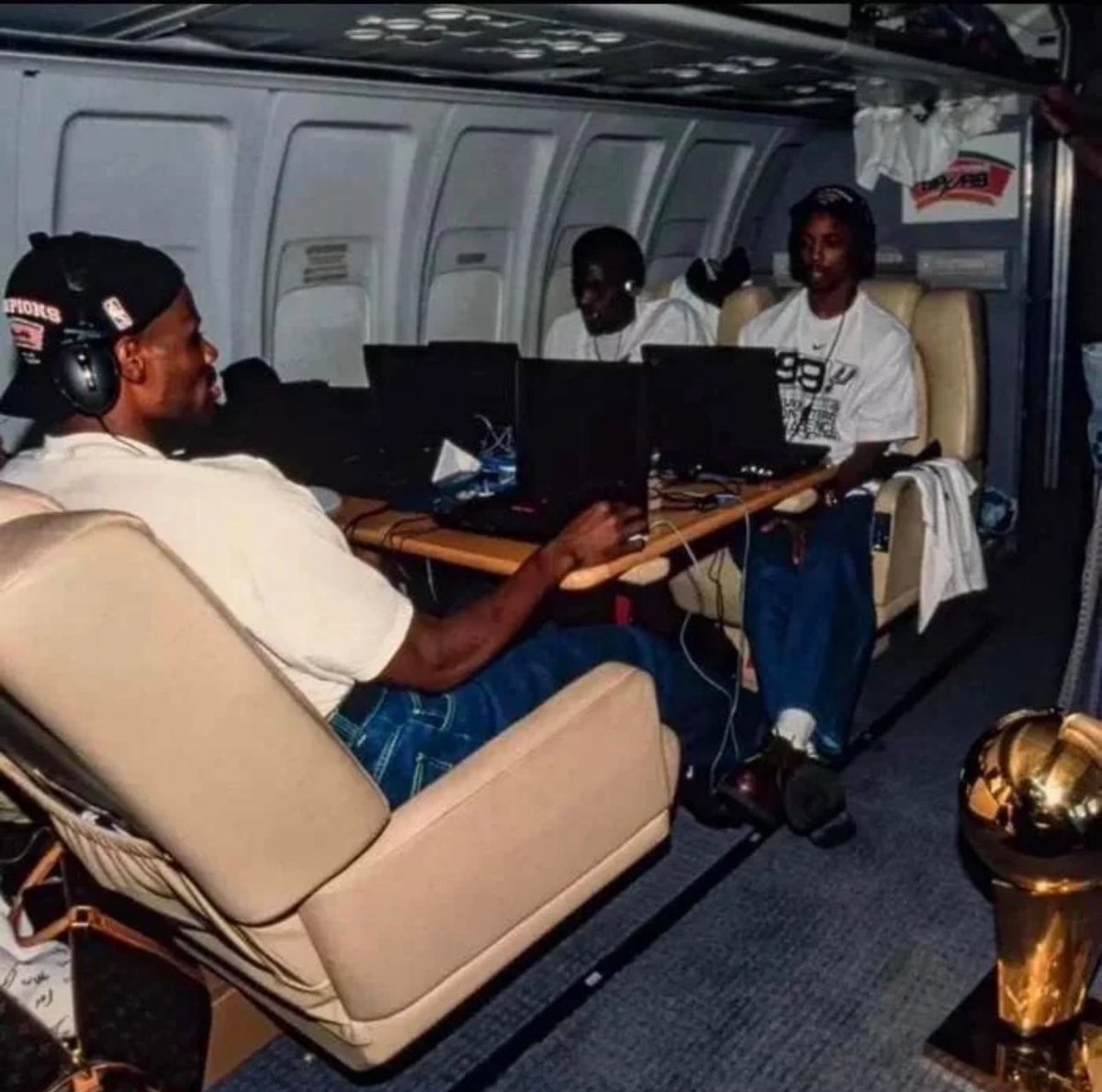 San Antonio Spurs basketball players play Starcraft on an airplane after winning the NBA Finals, 1999.