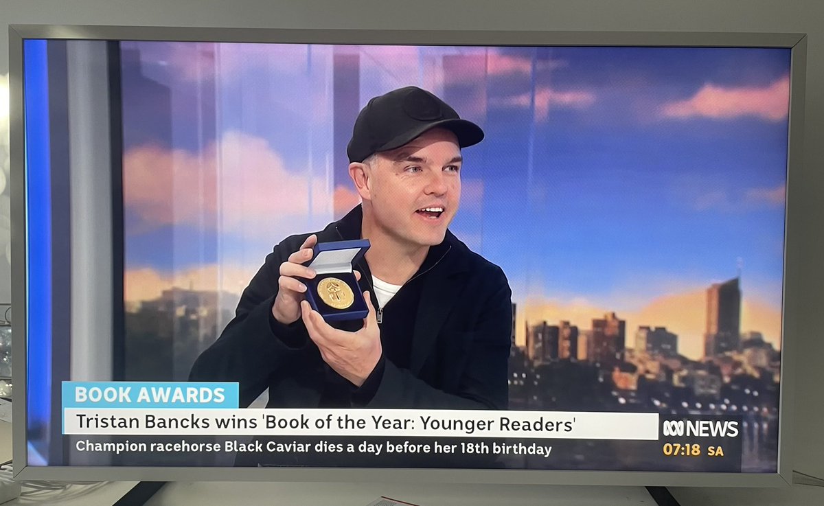 So cool to see awesome author <a href="/tristanbancks/">Tristan Bancks</a> on <a href="/ABCTV/">abctv</a> Weekend Breakfast this morning, brandishing the shiny, well-deserved <a href="/TheCBCA/">The CBCA</a> Book Of The Year award medal for his gripping Younger Reader novel ‘Scar Town’. Go Tristan!! 🤩🥇📗