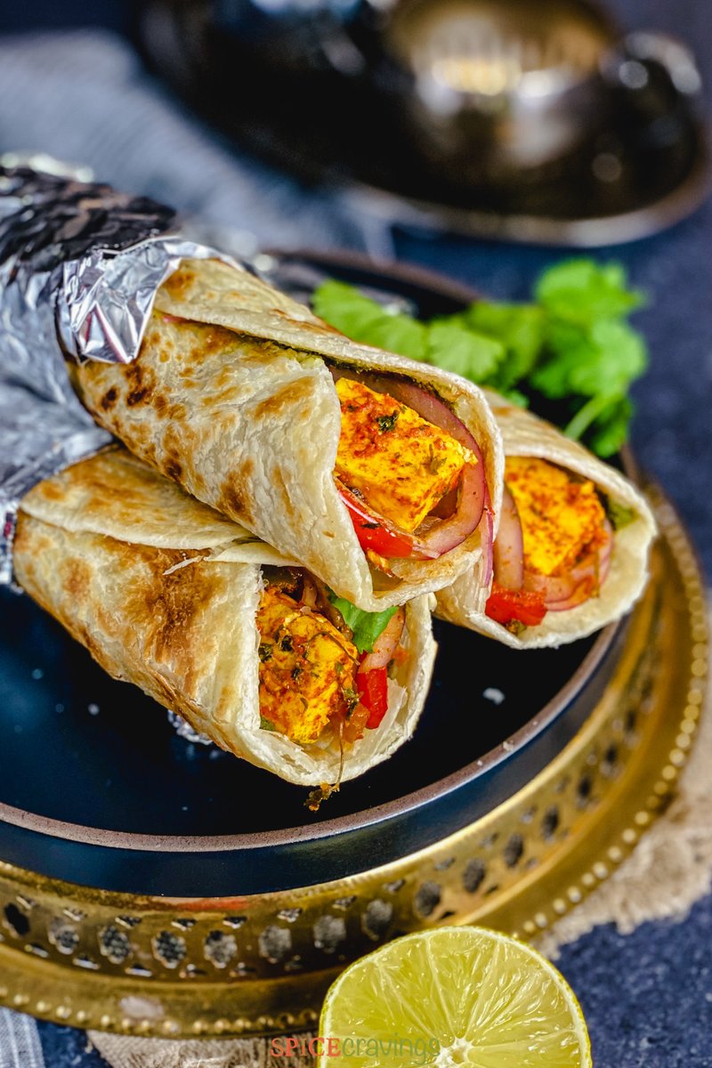 You'll love this Paneer Kathi Roll, or Paneer Frankie 🧈, a flavorful, aromatic, &amp; totally delicious Indian Vegetarian Wrap. Made with marinated paneer (cheese) &amp; veggies wrapped in a crisp paratha in 30 minutes.  spicecravings.com/paneer-kathi-r…