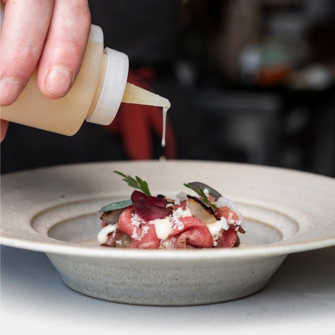 SepiaChicago's tweet photo. Pastrami-cured and smoked beef carpaccio with spring onion and smoked onion tallow, nestled upon brioche and finished with burnt onion consommé.

An ode to onion, meticulously layered in every bite. https://t.co/HSgbskCzTa