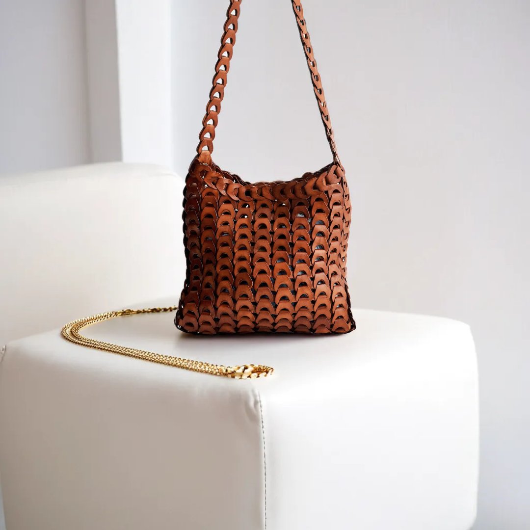 stysion's tweet photo. Introducing our latest innovation at Stysion: a versatile bag with unique leather medallion straps linked like a chain, creating a distinctive, textured look. Wear it over the shoulder or as a crossbody—sustainably designed to adapt to your style. #StysionDesign #handmade https://t.co/045JcKAz0A