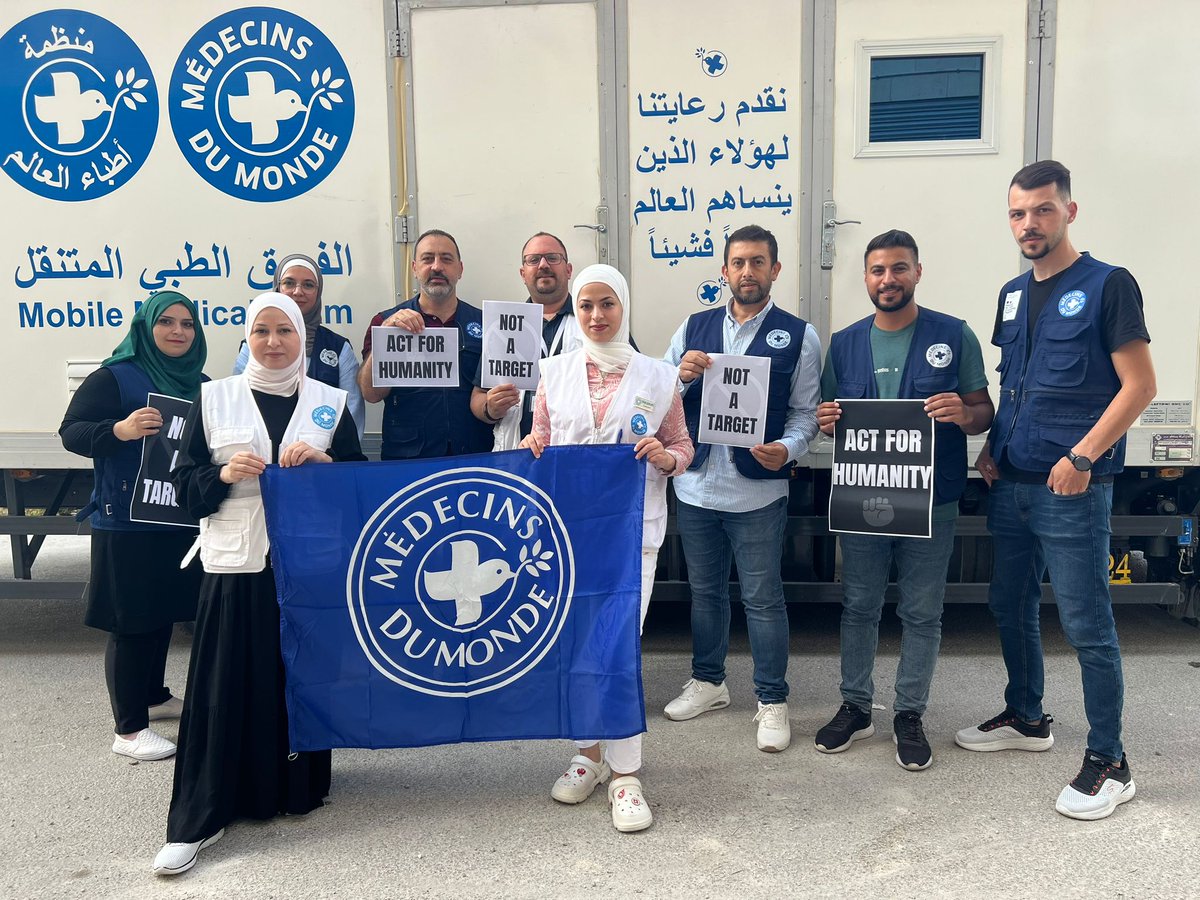 MdM_France's tweet photo. #WorldHumanitarianDay : 
Nos équipes en #Palestine mobilisées.

Dans leurs mains, la photo de notre collègue Maysara Rayyes tué avec sa famille dans les bombardements israéliens.

Les humanitaires ne sont pas des cibles.
Les civils ne sont pas des cibles.

#NotATarget https://t.co/BfXaVcNpVv