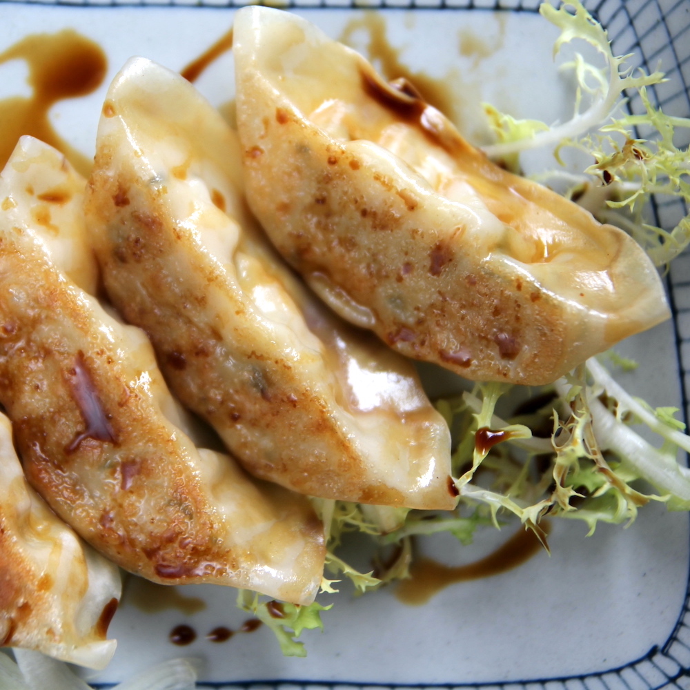 Vegetable filled gyoza dumplings with black rice vinaigrette have been one of our most popular small plates since we've opened. These timeless dumplings and always so satisfying.