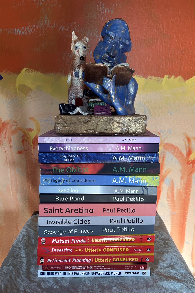 A_M_Mann's tweet photo. @doloughlin32 All my work in reverse chronological order, the bottom five are from 2004~2008 and published by McGraw-Hill. All of my fiction is self published. All were queried first. There is a learning curve. But not a steep one. The sculpture atop the stack was done by my wife. Do it! https://t.co/xnPJRvJ1TP