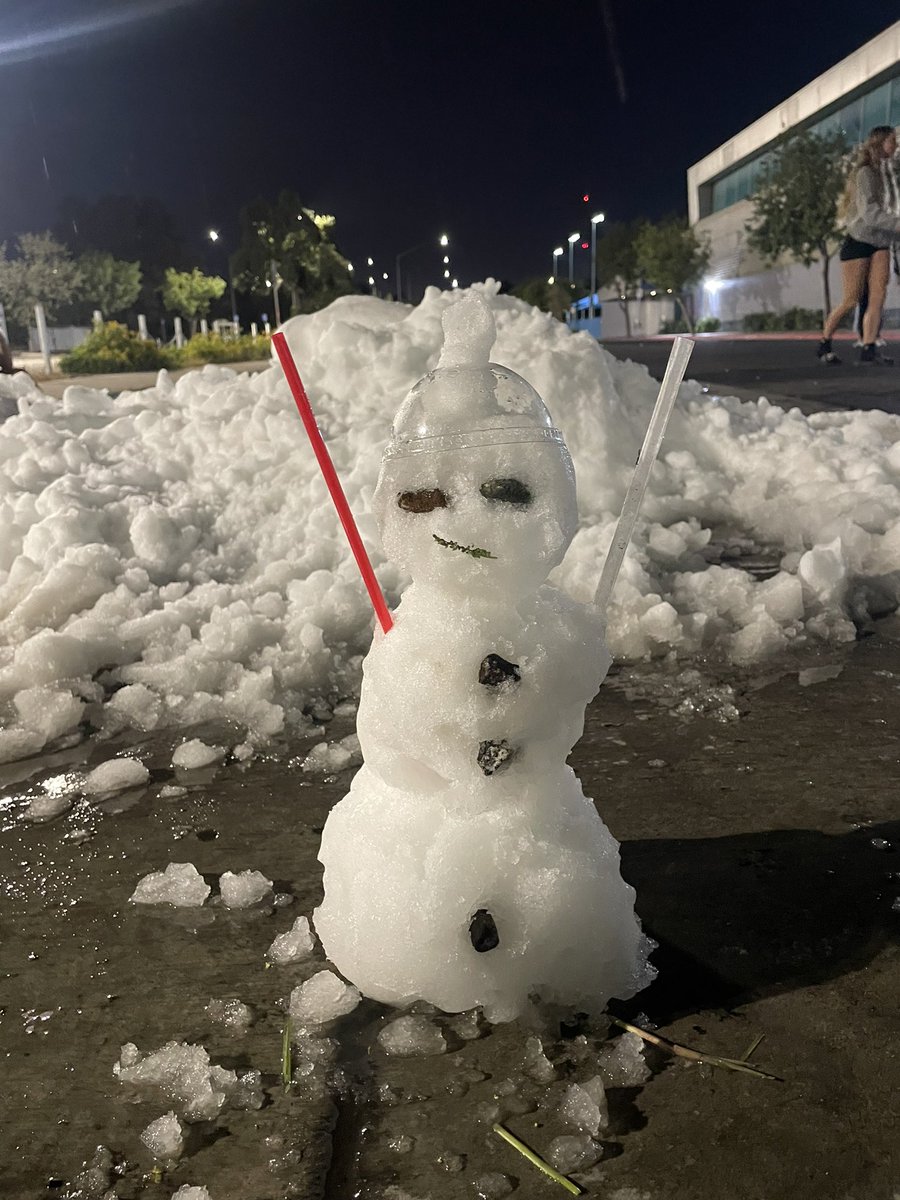 Snowman on the sidewalk in summer