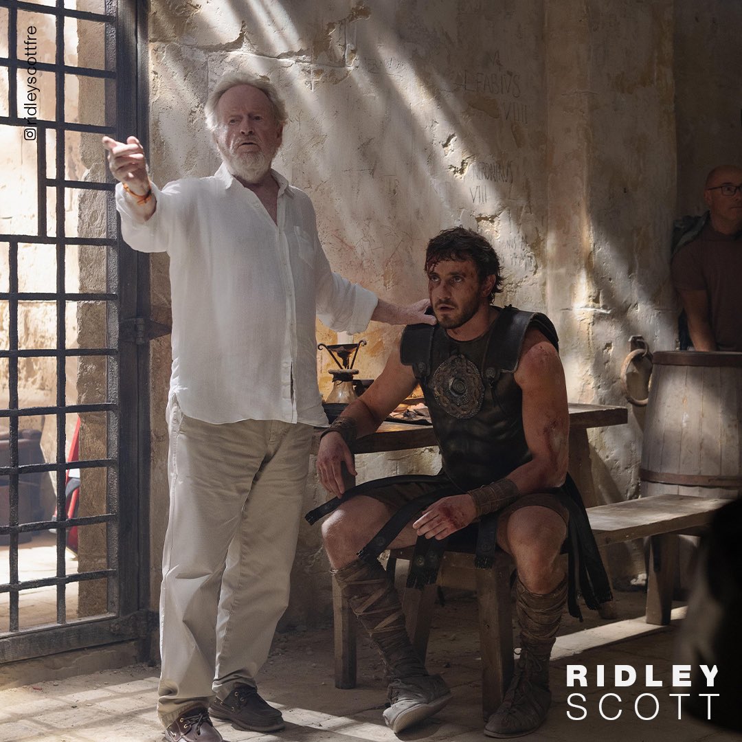 After his home falls into the hands of tyrannical Roman emperors, Lucius is forced into the Colosseum. To restore Rome's lost glory to its people, he must draw strength from his past. This photo is a behind-the-scenes shot from the film.

#RidleyScott and Paul M. in #Gladiator II