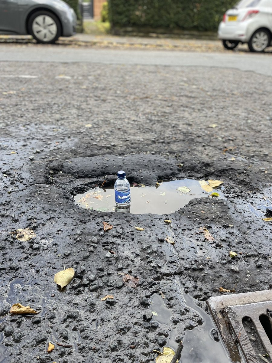 CarrieCheyne's tweet photo. Pic of a deep pothole which resulted in a burst tyre after going through it in heavy rain last night. It looked like a regular puddle. I took some pix of it today to show location etc. it’s on Victoria Park Drive North, Jordanhill @MyGlasgowCC 
Location: https://t.co/CiD6rAlmqF https://t.co/X1nOK78W4z