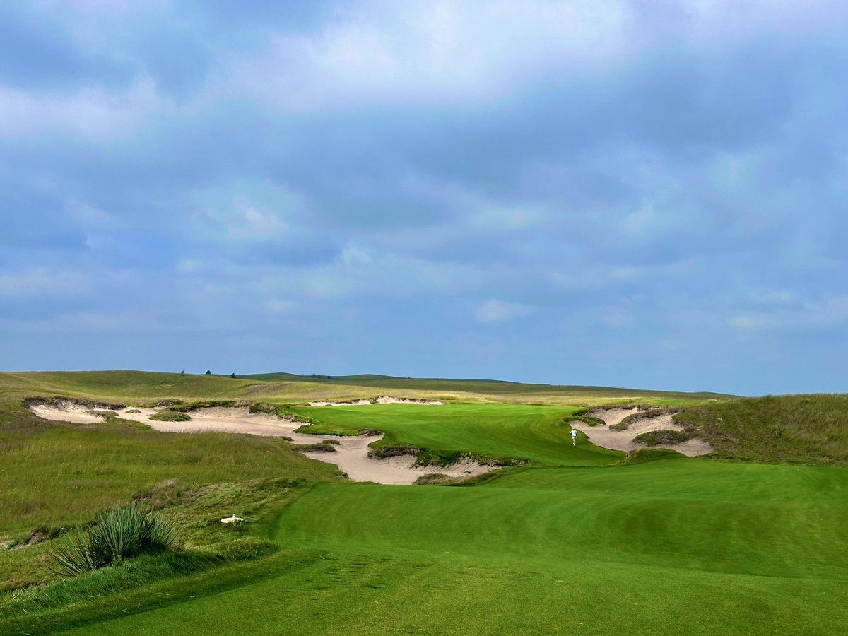 Top100Rick's tweet photo. GrayBull Club 
2024 - David McLay Kidd

GrayBull is a private facility that has been designed to be the ultimate stay and play getaway for groups. Only a max of 60 players will be on-site at a given time. It’s part of the Dormie Network, a network of now 7 private golf clubs that its members can all use. 

The site is a giant expanse of rolling sand dunes. You can’t see anything for miles and it adds to the remote feeling. You often can only hear the breeze and crickets, a great reprieve of our normal lives in the city. 

The course is a fun, modern take on the sand hills. A unique feature is that the cart “paths” are just fairway. Narrow strips of fairway connect the holes and you pull right up to your tee box. It speeds the game up and it’s nice to see no cart paths. 

The fairways are wide, but there are some forced carries and tricky angles. The lay ups are tough on a couple of the par 5’s, not unusual to lay up into trouble if not totally focused. The greens have lots of movement and funnels, also being new turf very firm. Quite a few have no green side bunkers, allowing for lots of putts from off the greens. 

The cottages are luxury and super well done. Most of them have 4 bedrooms, a bar, and common area. It is an all-inclusive stay, so food and drink is included. The steaks are incredible! The service is amazing, Dormie hospitality is always excellent. 

GrayBull is an impressive entrant into the Nebraska sand hills. I think DMK had a tough challenge to differentiate the golf course from the competition and he did a very good job. Playable, fun, beautiful, and the hospitality is second to none. 

If you can snag an invite, I highly recommend the journey!