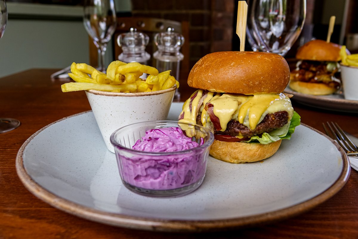 Can't beat a pub classic! 

Dunwood Farm 8oz beef burger, streaky bacon, Cheddar cheese, burger sauce, dill pickle, gem lettuce, tomato, brioche bun, red cabbage and spring onion slaw, French fries 🍔⁠
⁠
Book your table 👉️ doganddoubletsandon.co.uk/book-a-table

#DogAndDoubletSandon