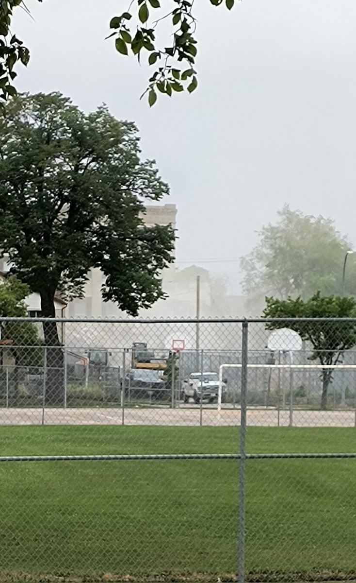 A loud crash from the 579 the McDermot building. A cloud of dust covers the building even the water hose can't disperse it.