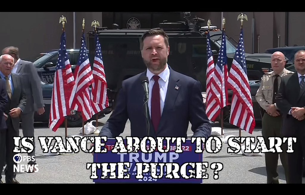 AxlonUndergrnd's tweet image. He’s outside of a police station with SWAT vehicles and armed people behind him surrounded by American flags. #WeirdAF #WeirdGOP