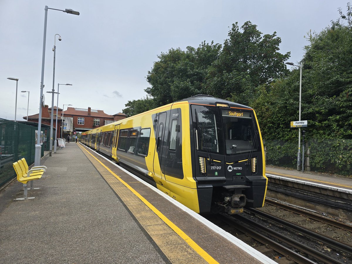 Iiamblundell's tweet image. Merseyrail class 777017 is seen at Formby Railway Station with a service to Southport. While Colas Rail DR73921 is seen waiting to enter the engineering block at Formby to do some tamping work. 
22.08.2024
@merseyrail 
@ColasRailUK 
#merseyrail 
#colasrail 
#engineeringworks