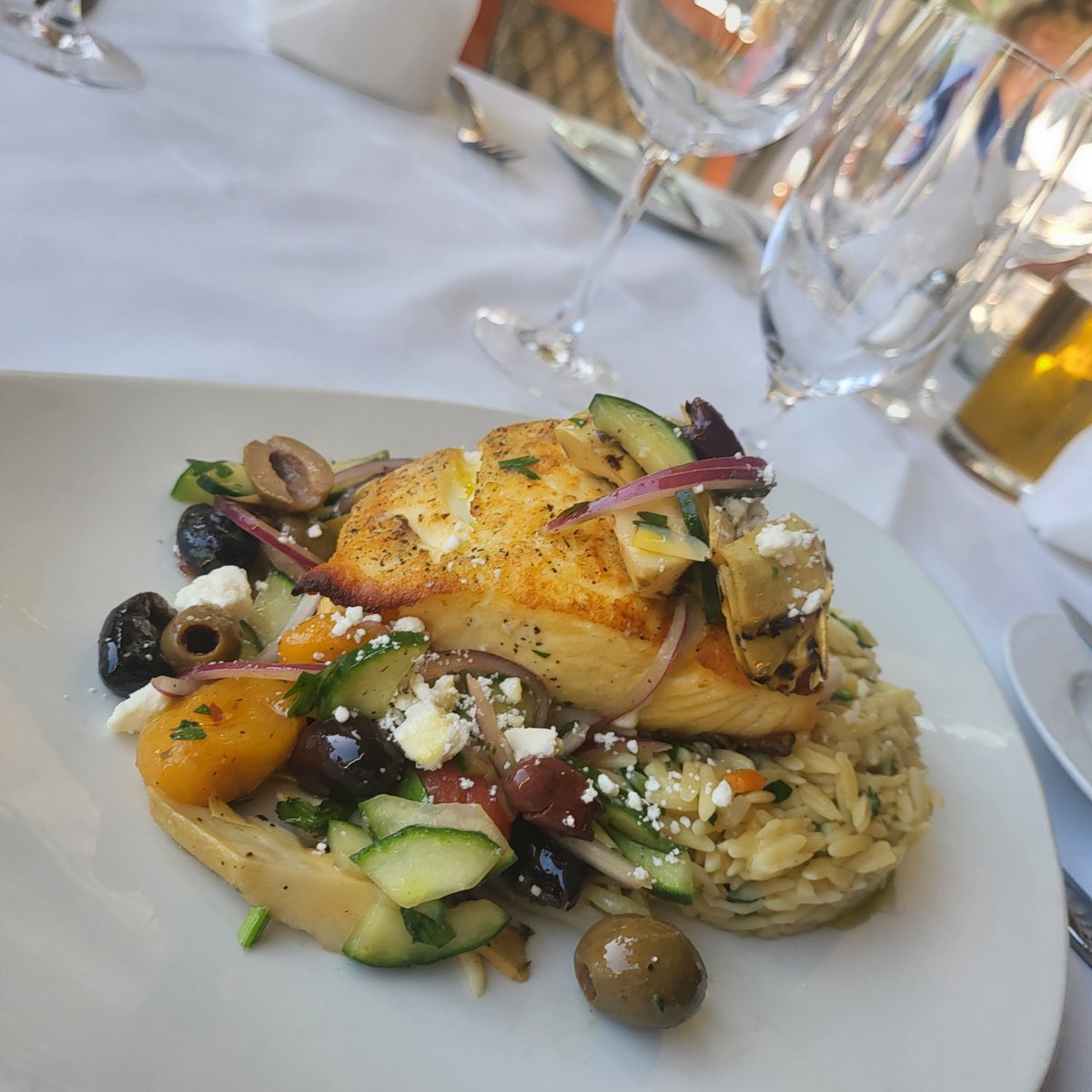 Pan seared halibut, fennel scented orzo, Mediterranean salad (grilled artichokes, mixed olives, cucumber, heirloom tomato, red onion, feta cheese) fresh herbs, oregano white balsamic vinaigrette feature by Executive Sous Chef Walter Balkiewicz