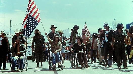 TammiMinoski's tweet photo. #OTD 1972: Paralyzed in Vietnam in 1968, #RonKovic (w/flag) led fellow veterans into the Republican National Convention in Miami Beach. When President #Nixon began to speak, he shouted, “Stop the bombing! Stop the war! https://t.co/s4BrNbxfU2 #VietnamWar #USHistory https://t.co/rL6YOmt0Du