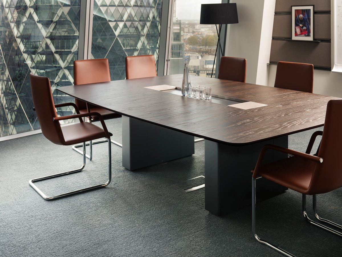 Our Object Tables take center stage in several meeting rooms of this esteemed Fortune 500 Company. Tailored in Fumed Oak with a central feature elegantly finished in Gunmetal and the signature stone plate, which smoothly glides across the tray to reveal power and data outlets.
