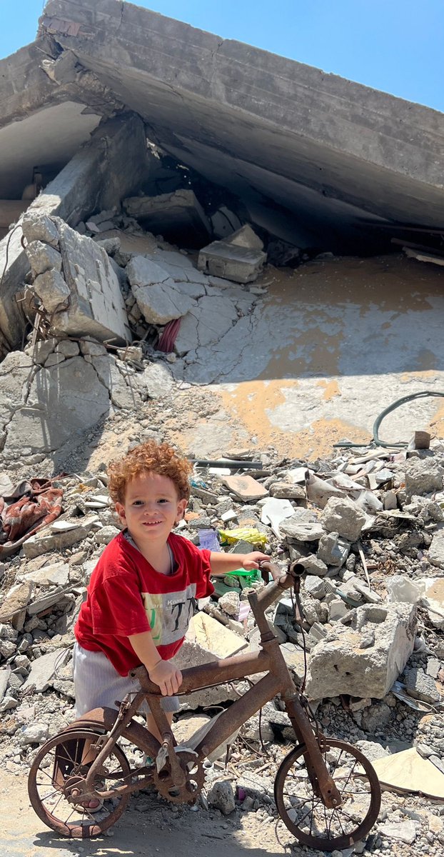 My little nephew Nejam has lost his family, house, and bicycle. He stands resilient among the rubble with his bicycle, telling the whole world: I own this land and belong to it ! 
Taken by <a href="/nnedr_1985/">Mahmoud Alneder🇵🇸</a>