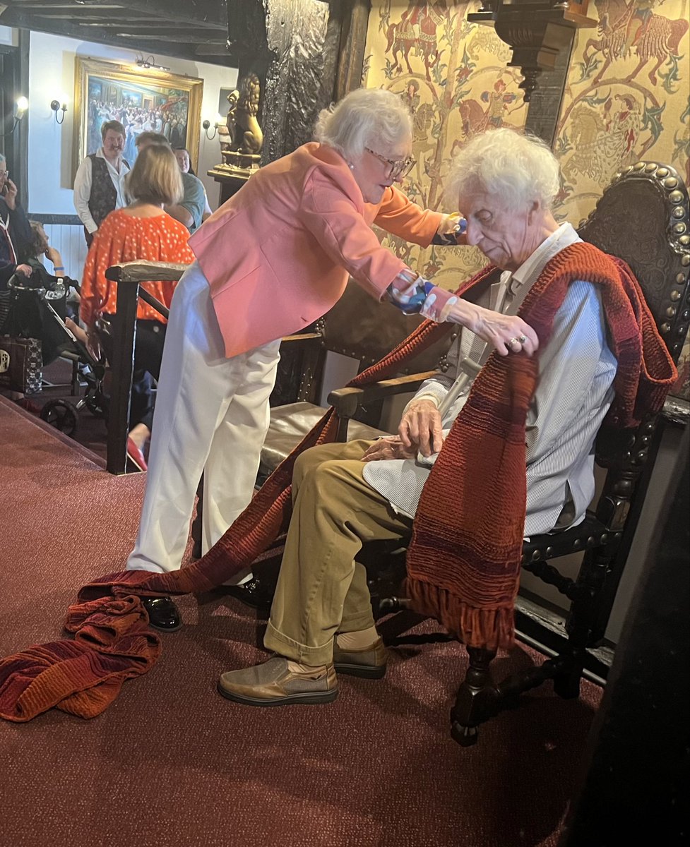 Lovely moment from <a href="/CygnusTweets/">CYGNUS ALPHA EVENTS</a> #DoctorWho event with Tom Baker at Rye. Legendary costume designer June Hudson places the famous scarf around Tom. Just as instinctively as would have been so before filming a scene. Tom Baker has a way of being both 90 and 20 at the same time!