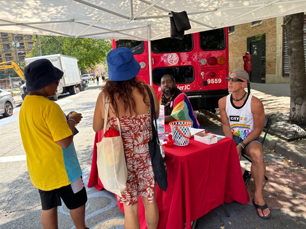 HealthierJC's tweet photo. Ruby, the red HHS bus out  at #Pride on Barrow St. with staff, who are happy to answer questions and offer free, confidential STI (STD) and HIV testing. Spread the word! Get tested and treated for a #healthierjc #jerseycity https://t.co/Dd69IBDINB #jerseycity https://t.co/b71v2cTrIL