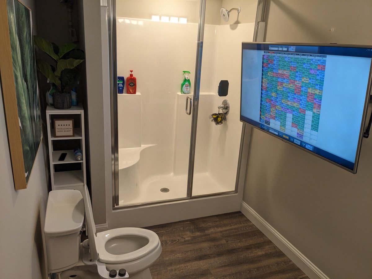 esaburruss's tweet photo. Y'all I went viral today for a potty TV of all things lol. It made it's debut at tonight's auction fantasy football draft and I'm sending this tweet from the throne watching the remaining rosters fill in. I am "Balls Deep" on the first column on the left. 

The bathroom is connected to the main area by a very long HDMI over Ethernet. Y'all probably didn't even know that was a thing but it is and it does very well