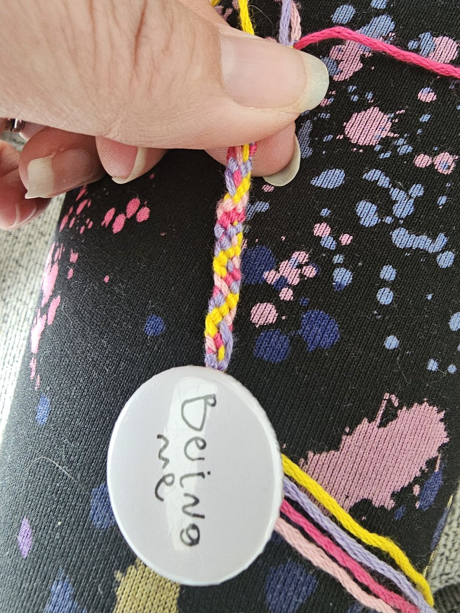 Watching my 8 y.o. make traditional friendship bracelets, thinking how wonderful it is to be 8y.o.! Adult weekends are bathroom cleaning, not time to craft 😭. Then I realised how apt it was that the only safety pin I could find for her was a 'being me' badge 🥰 <a href="/mcgregor_marie/">Marion Burns</a>