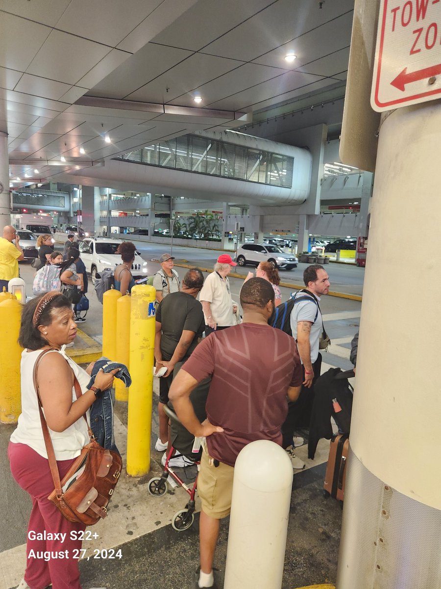 ThaRightTone's tweet photo. The fact that @AmericanAir has numerous terminal gates at MIA Airport and it took 45 minutes to find a gate for our landed flight is beyond unprofessional. Here is a photo of all the people who are in the same boat as us outside fighting to get on the hotel shuttle! https://t.co/lsVoXKHrgM