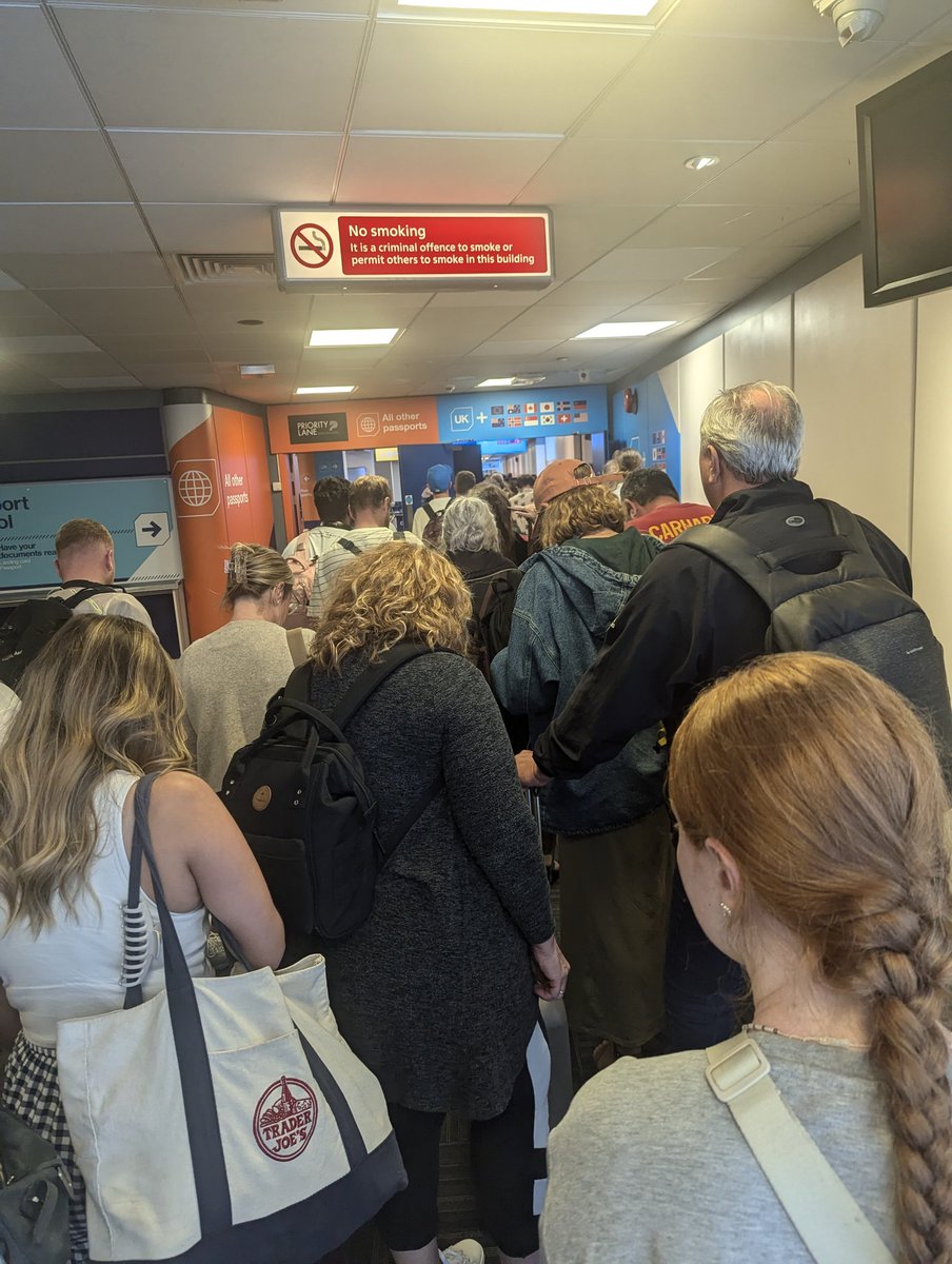 HLU1982's tweet photo. @GLA_Airport you need to sort yourselves out. On way out, I queued 30 mins to bag drop @easyJet while 6 staff members had a lovely little gossip. Security was it's usual nightmare, another 30 min wait. I've just returned &amp; this is the queue at passport control. https://t.co/Ti5zos4OFQ