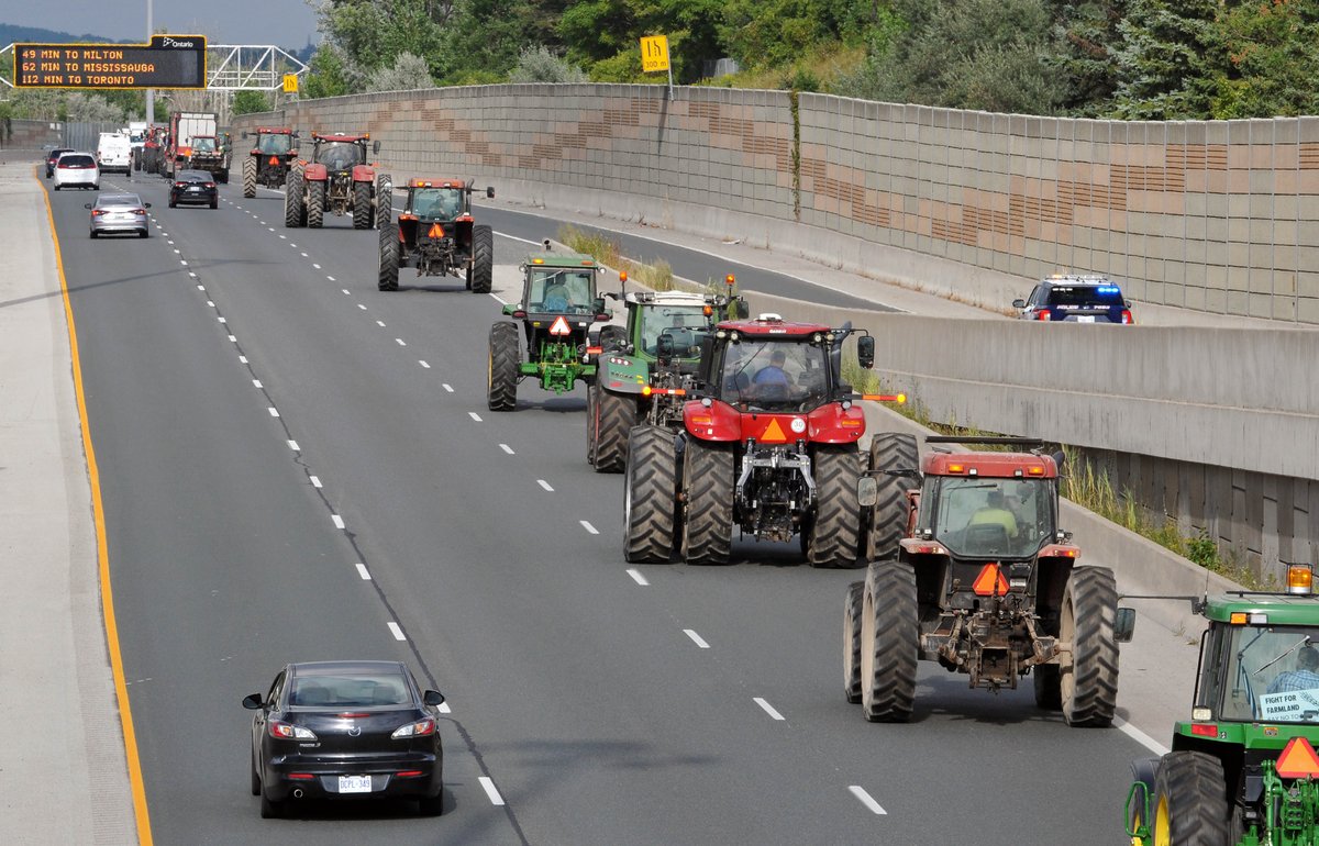 A long line of tractors, bound for regional headquarters, wound through #WaterlooRegion on Wednesday in a protest against the Wilmot land assembly.