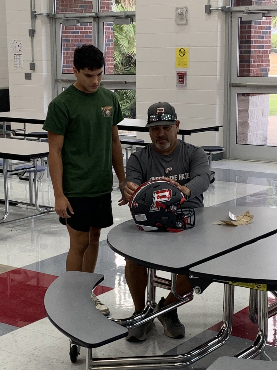 DBack_Football's tweet photo. Head Coach Eddie Galindo helping his son Malakai put on his stickers!
#DecalsWithDad https://t.co/p9EfaJweis