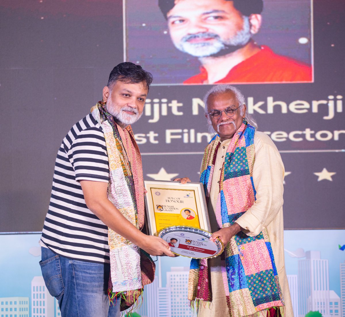 Srijit Mukherji receiving the prestigious Bengal to Nation Award from Pt. Tarun Bhattacharya at the BrandEdge event for the Best Film Director. A well-deserved recognition for his outstanding contributions to cinema. <a href="/srijitspeaketh/">Srijit Mukherji</a>