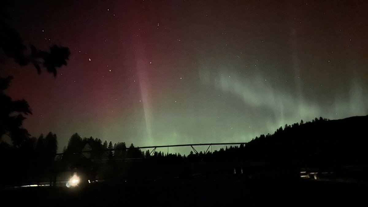 My husband farming under the Northern Lights.